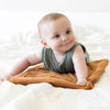 A little baby crawls on top of a Camel Colored Lush Saranoni Blanket. The soft blanket is a small blanket and a baby blanket or toddler blanket.