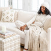 Woman cozying up to blanket, with her beautiful Moonbeam BAMBONI® HATS - Saranoni