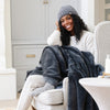 Woman smiling, sitting in a cozy chair with her Charcoal BAMBONI® HATS - Saranoni