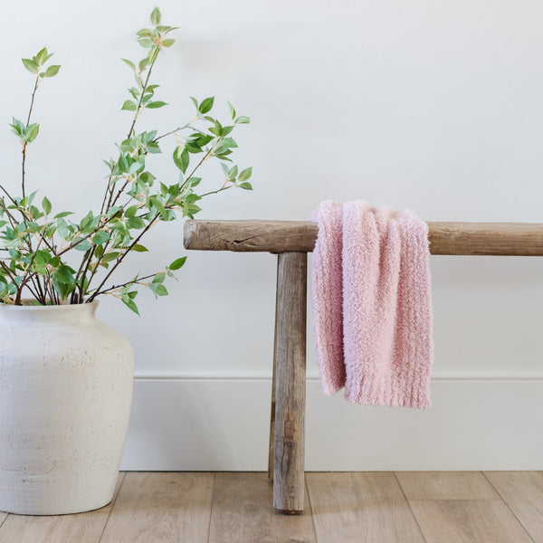 Beautiful light pink BAMBONI® MINI BLANKET set on wooden bench - Saranoni