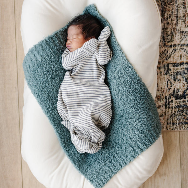 Newborn baby swaddled and laying on super soft and stretchy blue BAMBONI® MINI BLANKETS - Saranoni