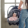 Baby being carried in carseat while snuggling with light pink BAMBONI® MINI BLANKETS - Saranoni