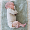 Baby boy falling asleep on super cozy and comfy BAMBONI® MINI BLANKETS - Saranoni