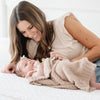 Mom and newborn baby girl cuddling in BAMBONI MINI BLANKETS - Saranoni