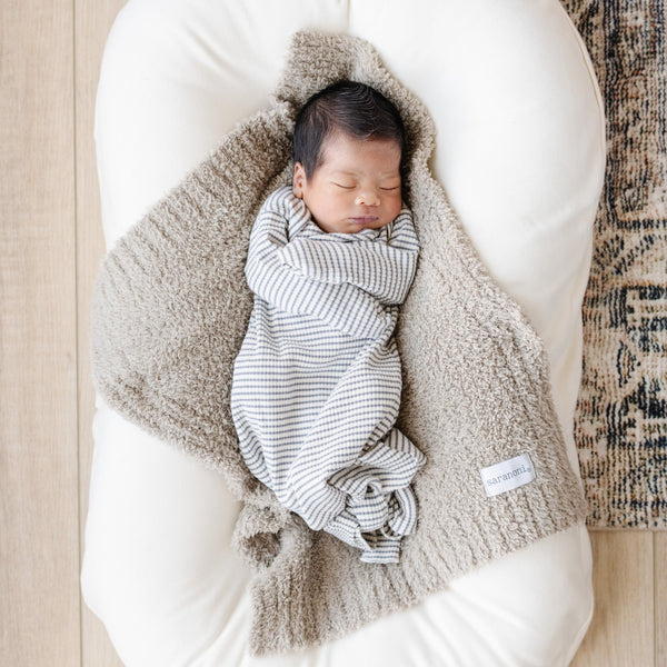 Sweet baby boy sleeping on super cozy BAMBONI® MINI BLANKETS - Saranoni