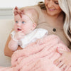 Mom and baby girl cuddling in super soft and cozy light pink BAMBONI® MINI BLANKETS - Saranoni