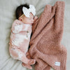 Baby girl falling asleep with soft and stretchy, pink BAMBONI MINI BLANKETS - Saranoni