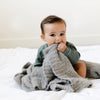 Young boy playing with super cozy neutral BAMBONI MINI BLANKETS - Saranoni