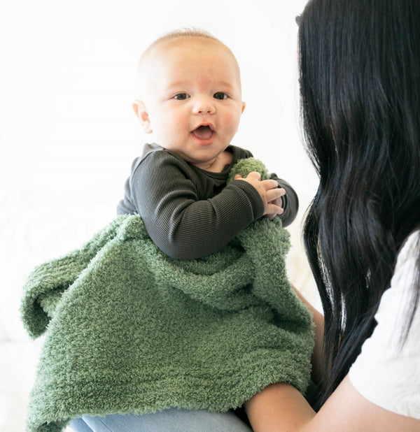 Happy baby boy playing in super soft, green BAMBONI MINI BLANKETS - Saranoni