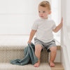 Little boy sitting on stairs holding favorite blanket - Blue BAMBONI MINI BLANKETS - Saranoni