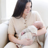 Mom holding newborn baby wrapped in oatmealBAMBONI® MINI BLANKETS - Saranoni