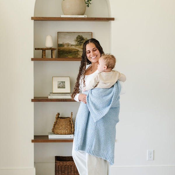 Mom and baby boy playing in beautiful home, with light blue BAMBONI® RECEIVING BLANKETS - Saranoni