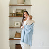 Mom and baby boy playing in beautiful home, with light blue BAMBONI® RECEIVING BLANKETS - Saranoni