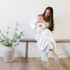 Mom and son sitting on beautiful wooden bench, wrapped in Ivory BAMBONI® RECEIVING BLANKETS - Saranoni