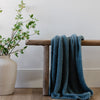 Beautiful home decor with plants, bench, and Spruce BAMBONI® RECEIVING BLANKETS - Saranoni