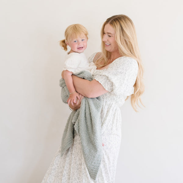 Mom and daughter laughing with Sage green, cozy BAMBONI® RECEIVING BLANKETS - Saranoni