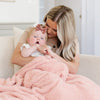 Mom snuggling into adorable baby girl with Peach BAMBONI® RECEIVING BLANKETS - Saranoni