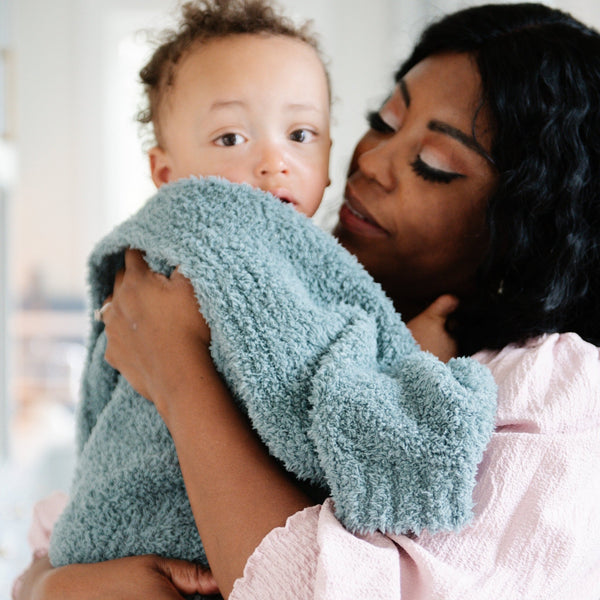 Mom and baby boy snuggling with beautiful, stretchy Spruce BAMBONI RECEIVING BLANKETS - Saranoni