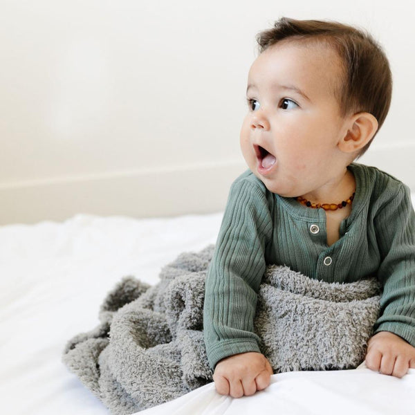 Baby boy playing on extra soft gray BAMBONI RECEIVING BLANKETS - Saranoni