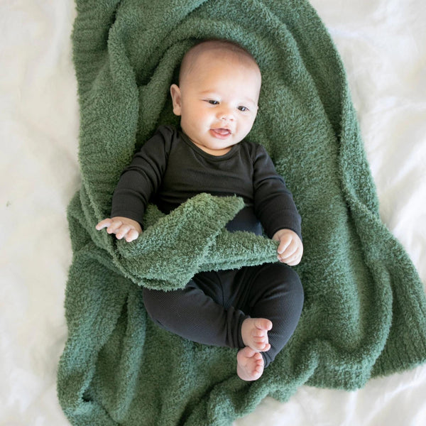 Baby boy playing on bed with stretchy soft Olive BAMBONI RECEIVING BLANKETS - Saranoni