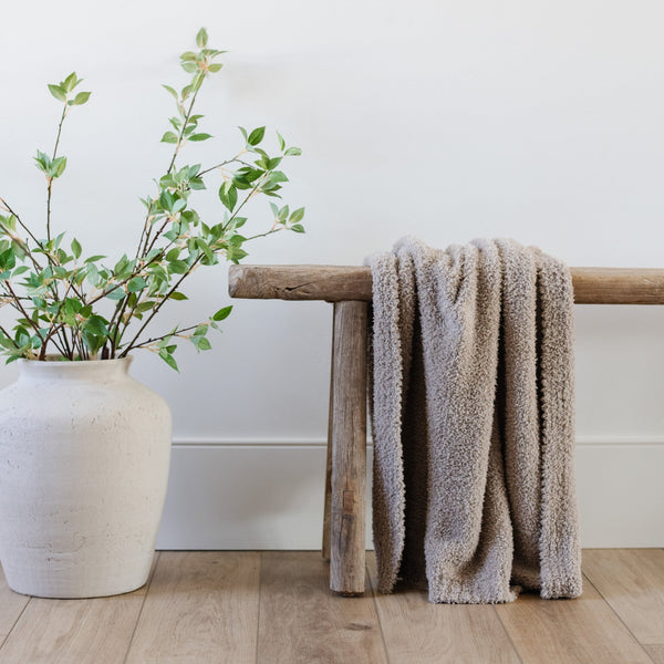 Beautiful Taupe blanket sitting on taupe bench with other home decor - BAMBONI® RECEIVING BLANKETS - Saranoni