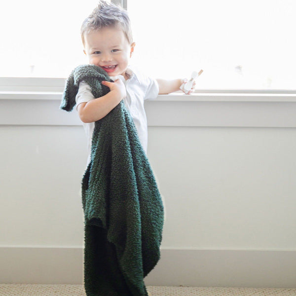 Little boy playing with Juniper stretchy BAMBONI RECEIVING BLANKETS - Saranoni