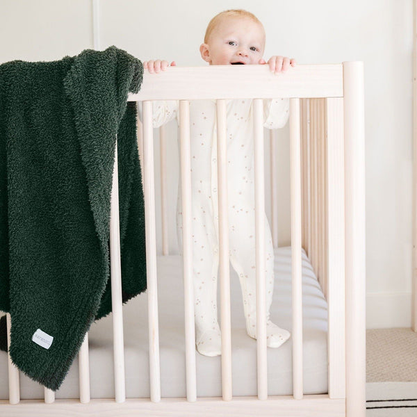 Baby boy playing in crib with beautiful Juniper BAMBONI RECEIVING BLANKETS - Saranoni