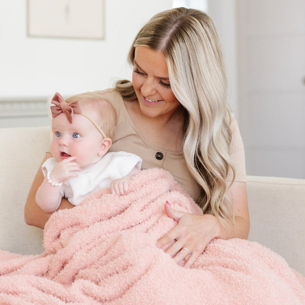 Mom and sweet baby girl snuggling in super soft Peach BAMBONI® RECEIVING BLANKETS - Saranoni