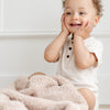 Baby boy smiling while sitting with Birch BAMBONI RECEIVING BLANKETS - Saranoni