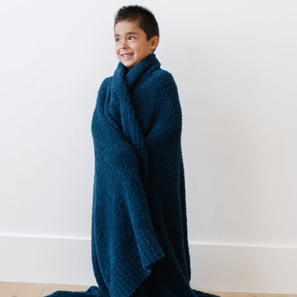 Little boy wrapped in super soft Nautical Blue BAMBONI THROW BLANKETS - Saranoni