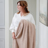 Woman holding her favorite super soft Birch BAMBONI THROW BLANKETS - Saranoni