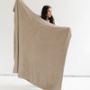 Girl stretching out and holding up beautiful Taupe BAMBONI THROW BLANKETS - Saranoni