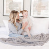 Mom and daughter playing on beautiful bedding with super soft Gray BAMBONI THROW BLANKETS - Saranoni