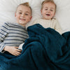 Two little boys snuggled in Nautical Blue BAMBONI THROW BLANKETS - Saranoni