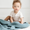 Baby boy sitting with extra soft and stretchy Spruce BAMBONI TODDLER BLANKETS - Saranoni