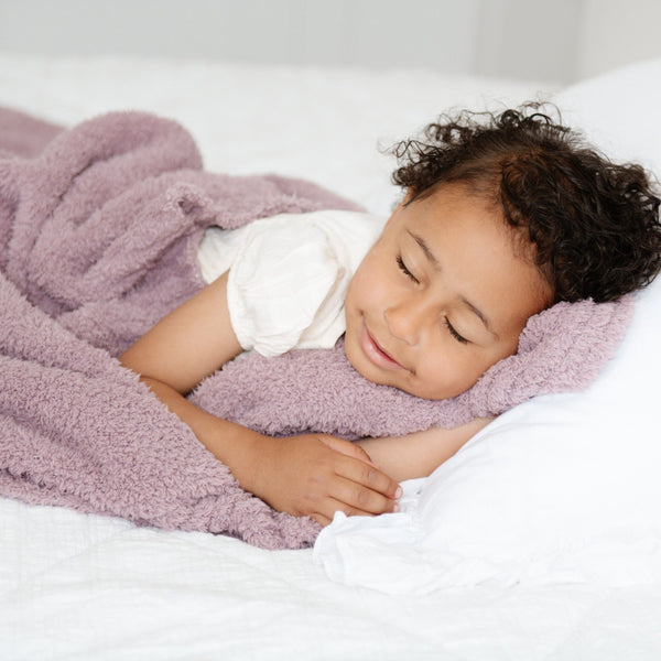 Young girl peacefully sleeping with Woodrose BAMBONI TODDLER BLANKETS - Saranoni