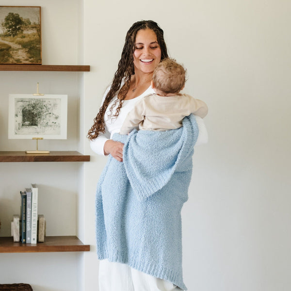 Mom playing with adorable baby boy wrapped in Light Blue BAMBONI® TODDLER BLANKETS - Saranoni