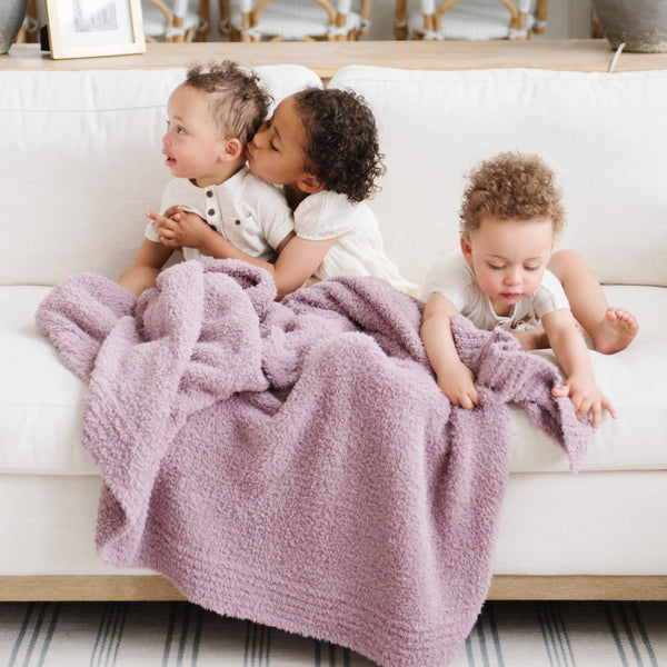 Three siblings playing on couch with soft, Woodrose BAMBONI TODDLER BLANKETS - Saranoni