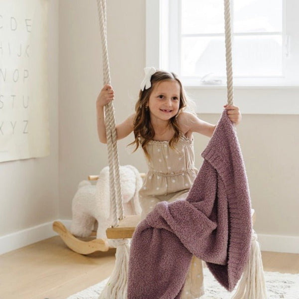 Little girl swinging with bright and fun Woodrose BAMBONI® TODDLER BLANKETS - Saranoni