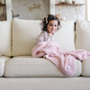 Little girl snuggling up with favorite, light pink BAMBONI® TODDLER BLANKETS - Saranoni