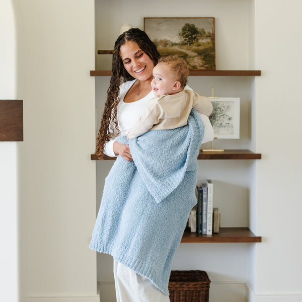 Mom swinging baby boy around in super stretchy and soft, Light Blue BAMBONI® TODDLER BLANKETS - Saranoni