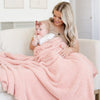 Mom and adorable new baby snuggling with beautiful Peach BAMBONI® XL BLANKETS - Saranoni