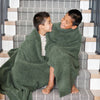 Two boys sitting on the stairs with extra luxurious Juniper BAMBONI XL BLANKETS - Saranoni