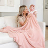 Mom and baby girl smiling with super soft and comfy Peach BAMBONI® XL BLANKETS - Saranoni