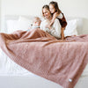 Little kids and mom playing on bed, wrapped in dusty French Rose BAMBONI XL BLANKETS - Saranoni