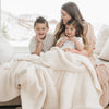 Mom and two little boys snuggled up in beautiful Ivory BAMBONI XL BLANKETS - Saranoni