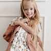 Little girl enjoying a breathable bamboo rayon muslin quilt featuring an elegant pattern.