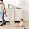 Father and son enjoying playtime together with a soft and breathable bamboo rayon muslin quilt with a stunning pattern, perfect for year-round comfort and style.