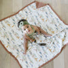 Little girl playing on an animal print elegant bamboo rayon muslin quilt with a striking pattern, offering a blend of comfort, breathability, and style.