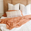 Beautifully crafted rust-colored bamboo rayon muslin quilt, showcasing a detailed pattern with a soft, airy feel for a cozy experience